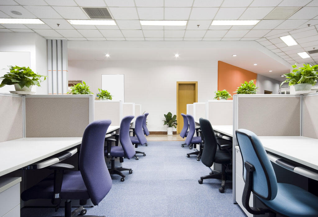 2 rows of work spaces with chairs a clean office space showing commerical cleaning services